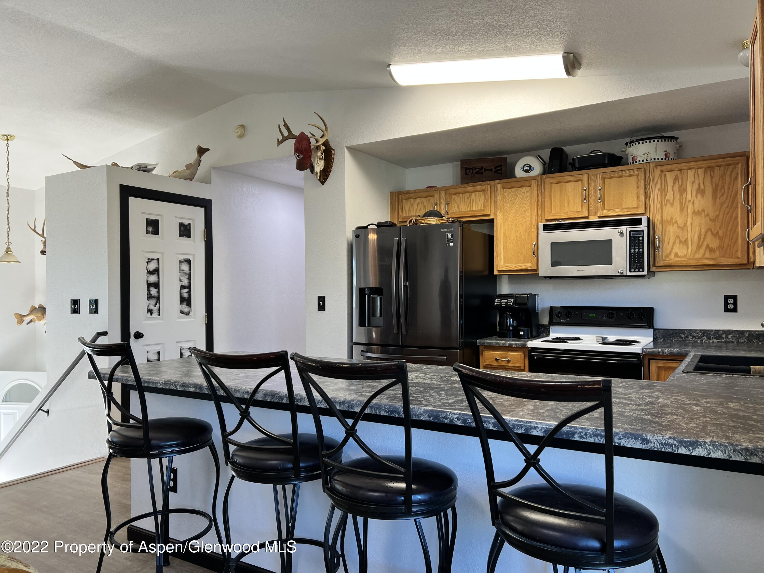 2447 Meadow Circle Rifle, CO 81650 - Photo 6 of 36 a view of a dining room with furniture