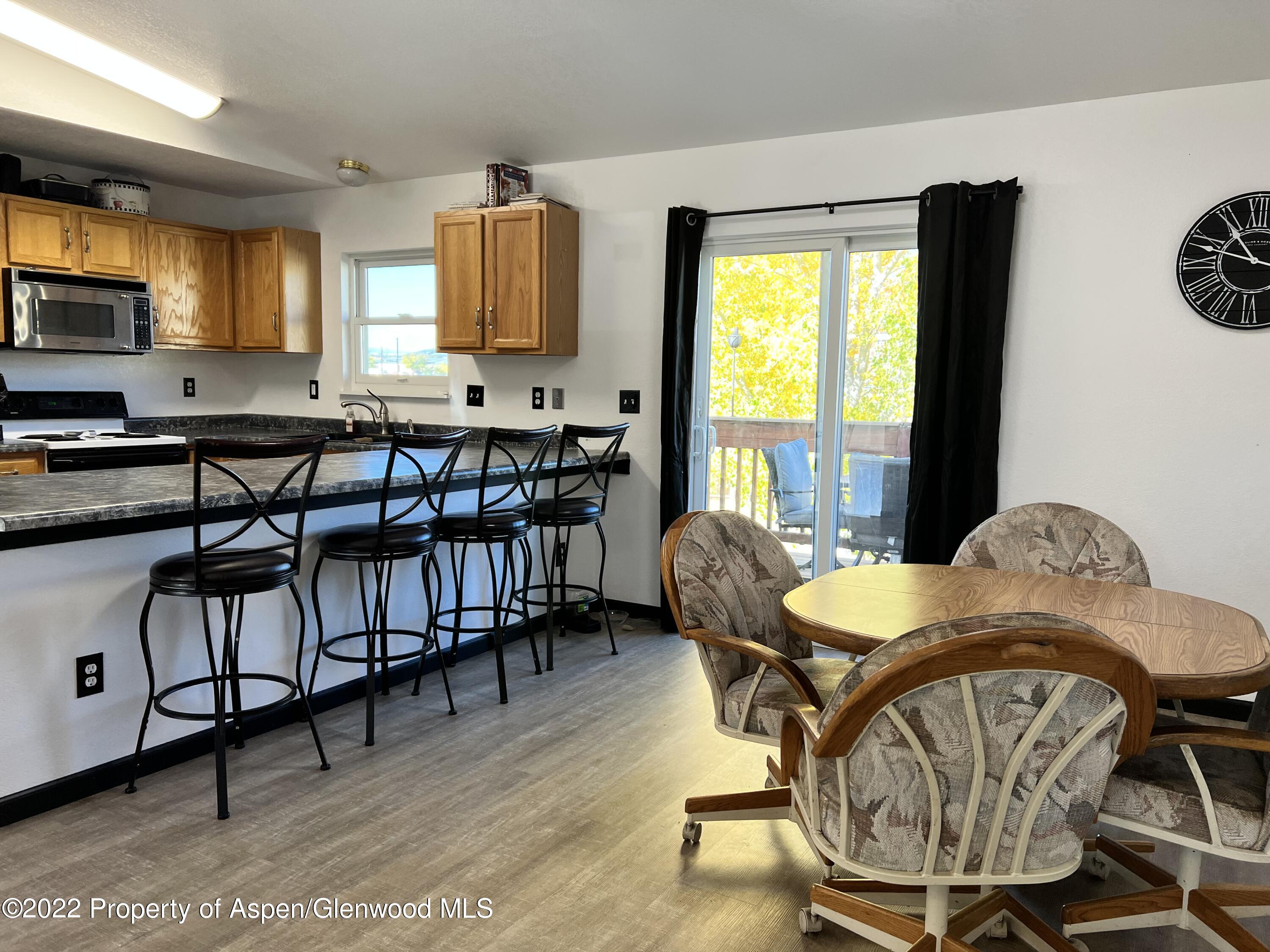 2447 Meadow Circle Rifle, CO 81650 - Photo 7 of 36 a view of a dining room with furniture window and wooden floor