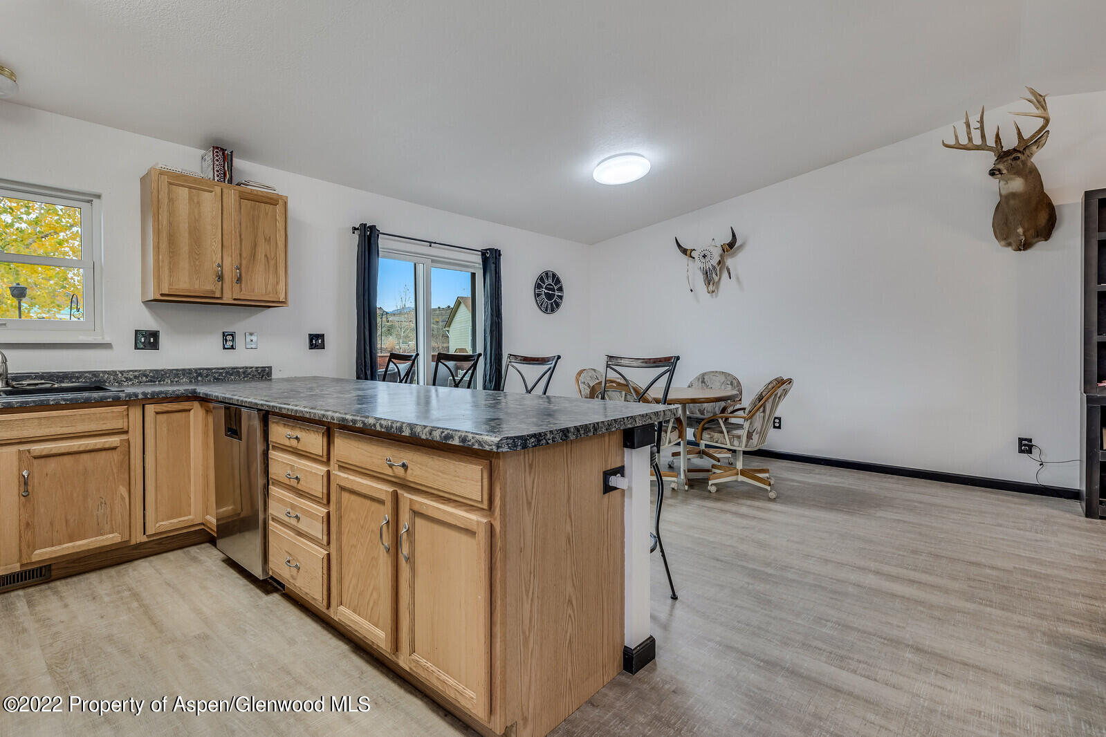 2447 Meadow Circle Rifle, CO 81650 - Photo 8 of 36 a kitchen with granite countertop a sink cabinets and wooden floor