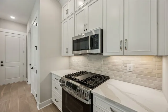 a kitchen with kitchen island a sink appliances and cabinets