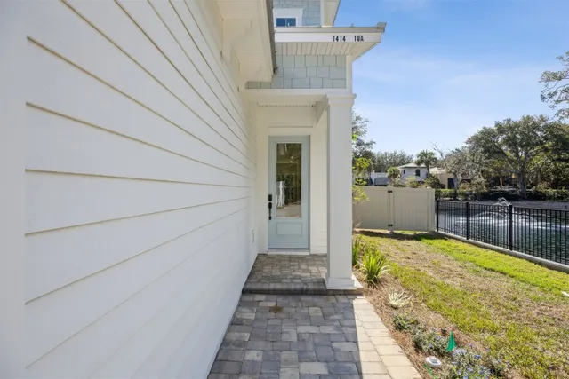 a view of a hallway with wooden floor and a bathroom