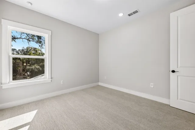 a view of backyard of house with green space