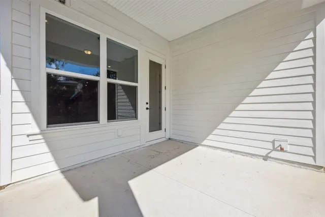an aerial view of a house with a yard and lake view