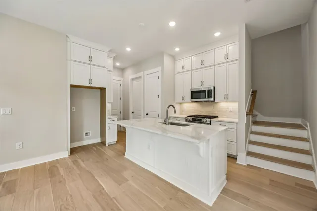 a kitchen with stainless steel appliances granite countertop a stove and a refrigerator