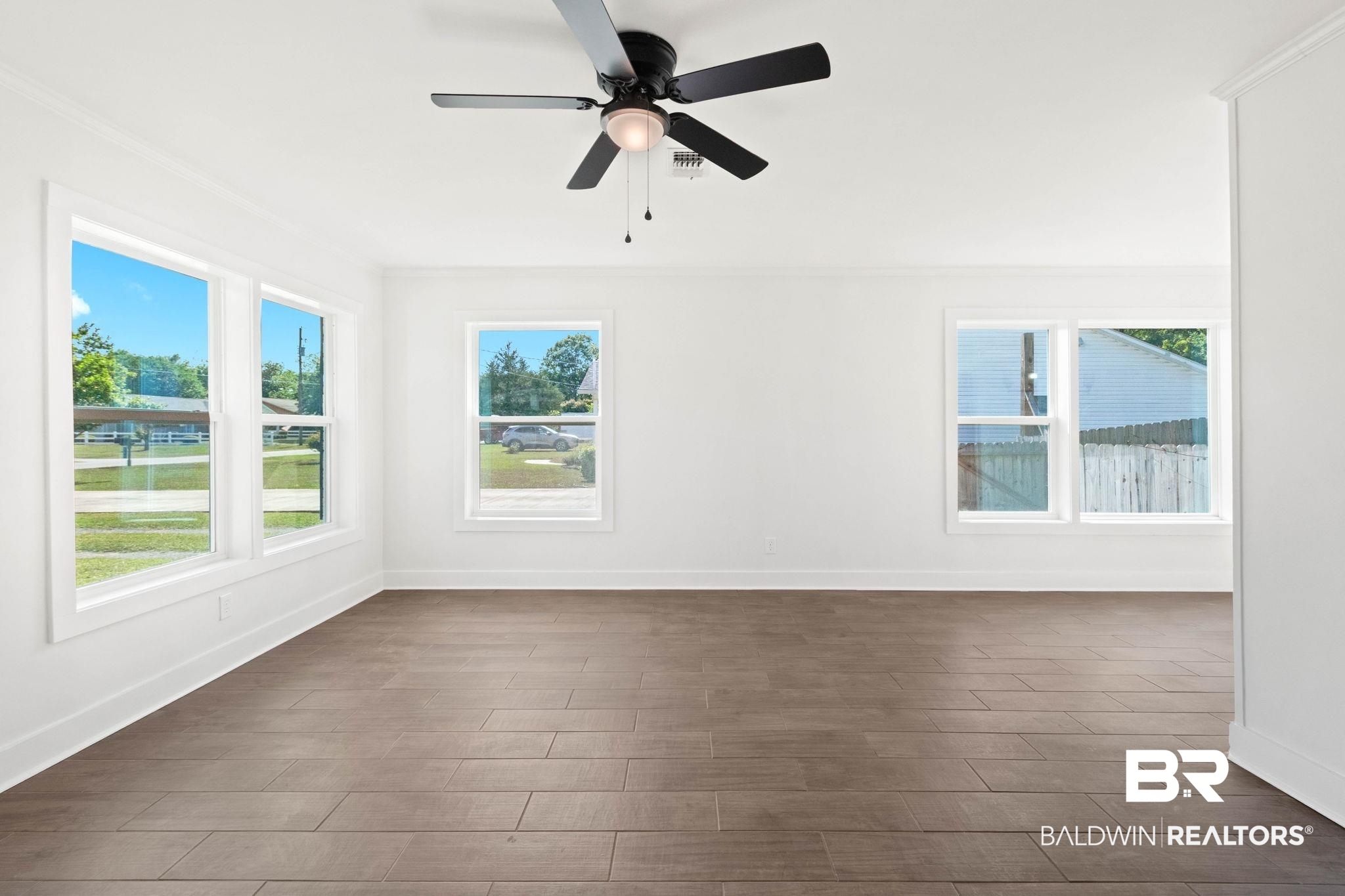 311 Cloverdale Road Atmore, AL 36502 - Photo 2 of 63 Bright interior space featuring wood-finish flooring, crisp white walls, and multiple large windows providing ample natural illumination