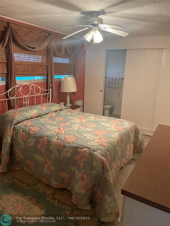 1888 Southwest 85th Avenue Davie, FL 33324 - Photo 12 of 18 a bedroom with a bed and a chandelier