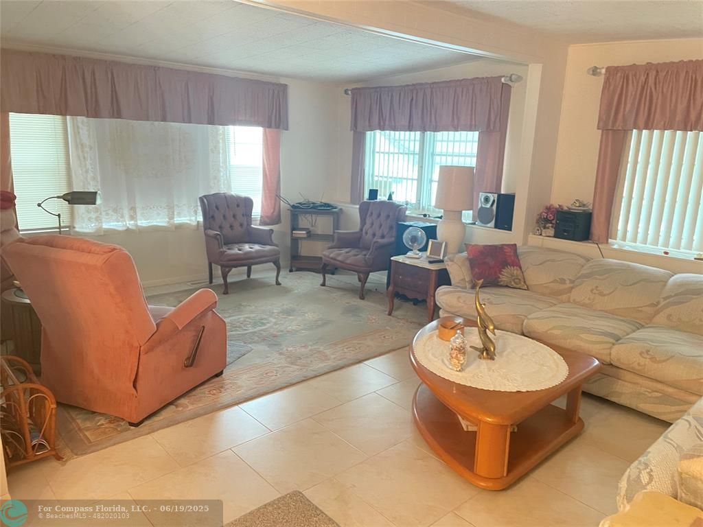 1888 Southwest 85th Avenue Davie, FL 33324 - Photo 4 of 18 a living room with furniture and a large window