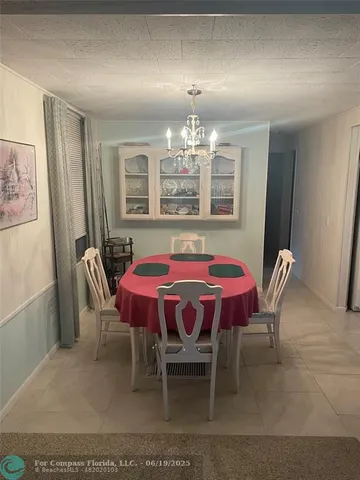 a dining room with furniture and chandelier