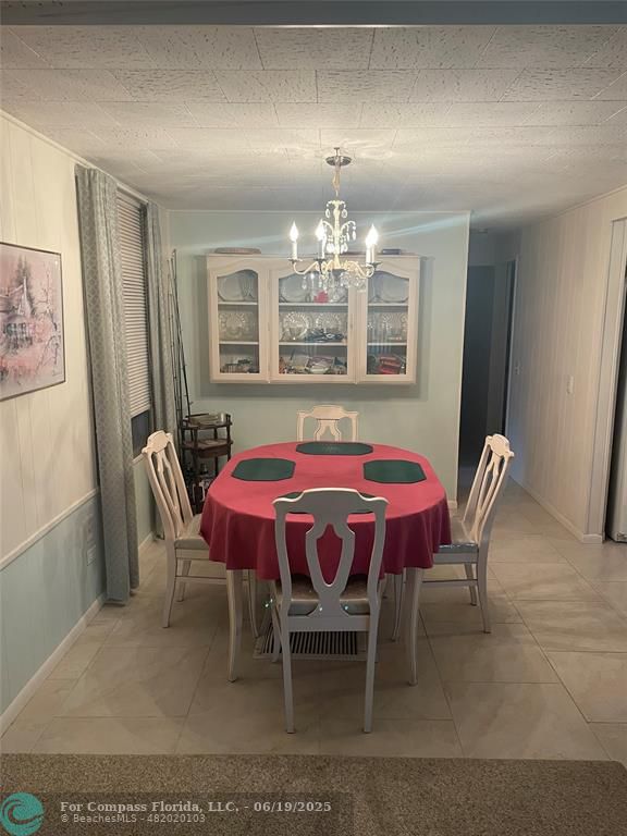 1888 Southwest 85th Avenue Davie, FL 33324 - Photo 9 of 18 a dining room with furniture and chandelier