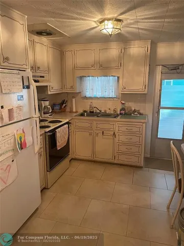 a kitchen with a stove top oven sink and cabinets
