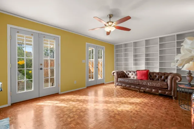 a living room with furniture and a ceiling fan