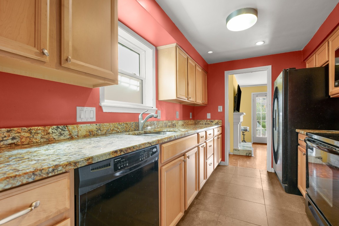 6631 Valleyside Road Austin, TX 78731 - Photo 16 of 33 a kitchen with stainless steel appliances granite countertop a stove and a refrigerator