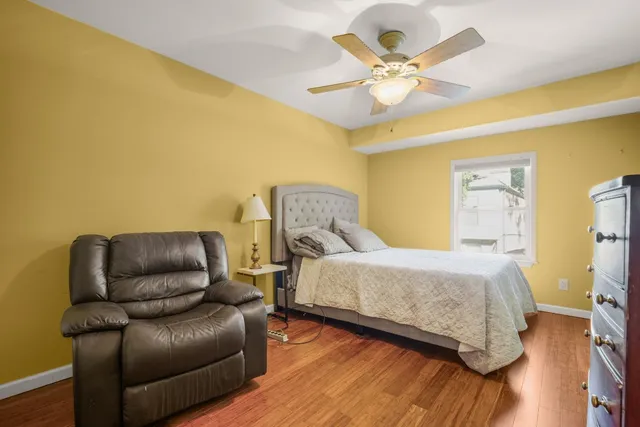 a bedroom with a bed and wooden floor