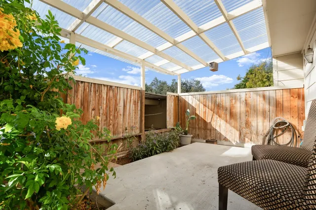 a view of a patio with table and chairs and potted plants