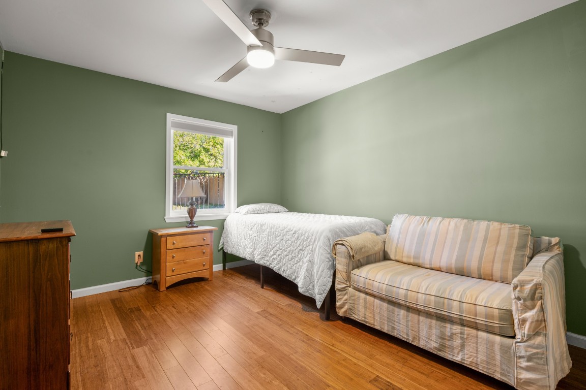 6631 Valleyside Road Austin, TX 78731 - Photo 21 of 33 a bedroom with furniture and a window