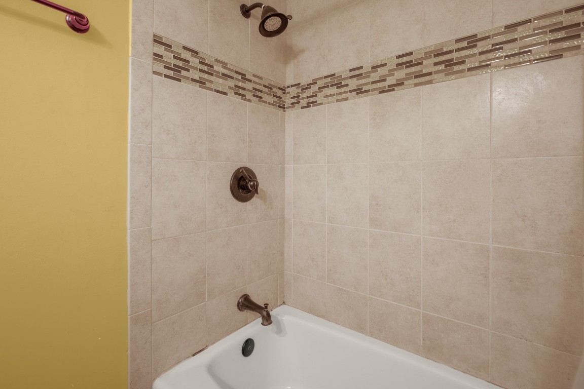 6631 Valleyside Road Austin, TX 78731 - Photo 23 of 33 a bathroom with a shower and a bathtub
