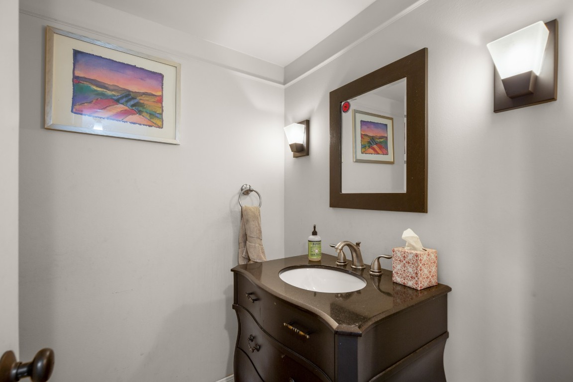 6631 Valleyside Road Austin, TX 78731 - Photo 25 of 33 a bathroom with a granite countertop sink and a mirror