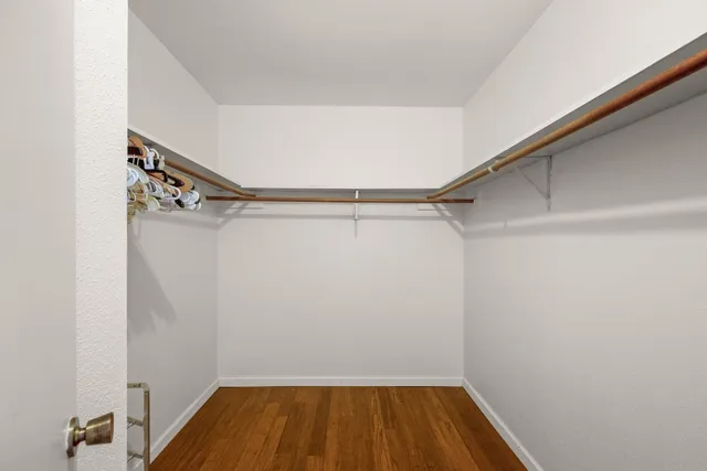 a view of a room with wooden chairs