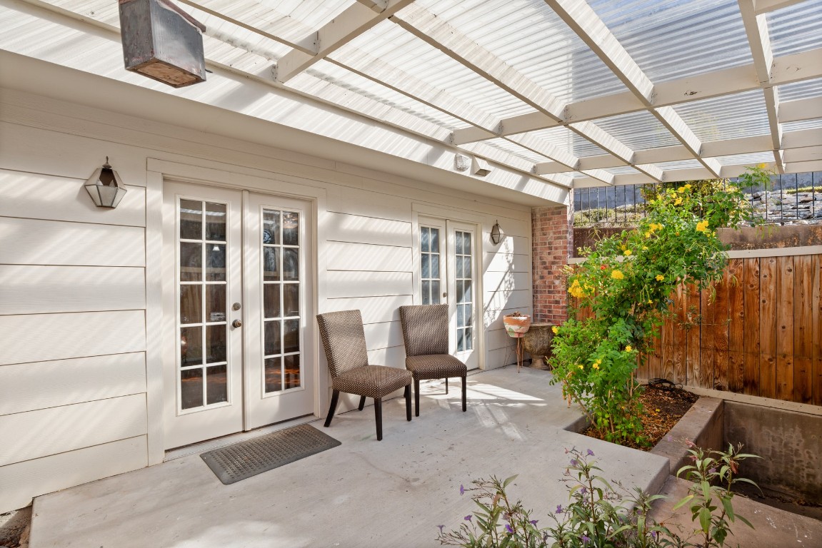 6631 Valleyside Road Austin, TX 78731 - Photo 3 of 33 a view of a patio with table and chairs and potted plants