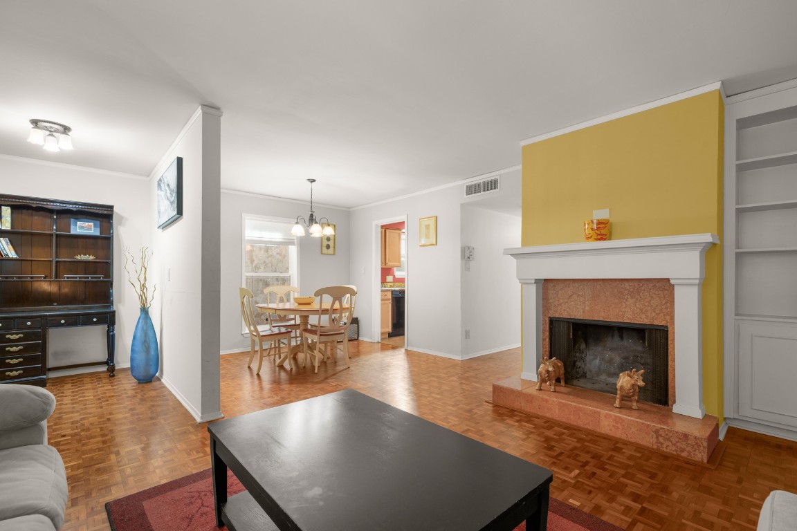 6631 Valleyside Road Austin, TX 78731 - Photo 7 of 33 a living room with furniture a fireplace and a flat screen tv