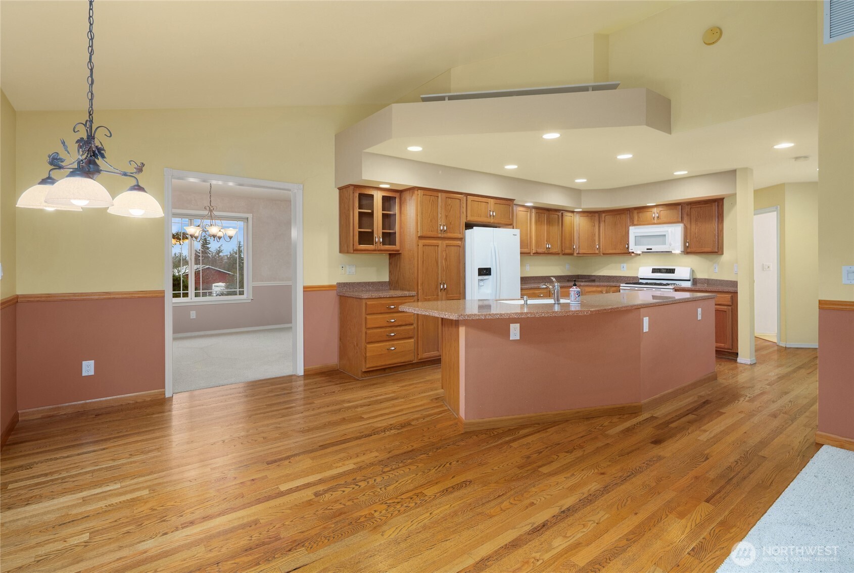 18663 Cascade Ridge Court Mount Vernon, WA 98274 - Photo 17 of 33 a kitchen with stainless steel appliances granite countertop a refrigerator a sink dishwasher a oven and a dining table with wooden floor