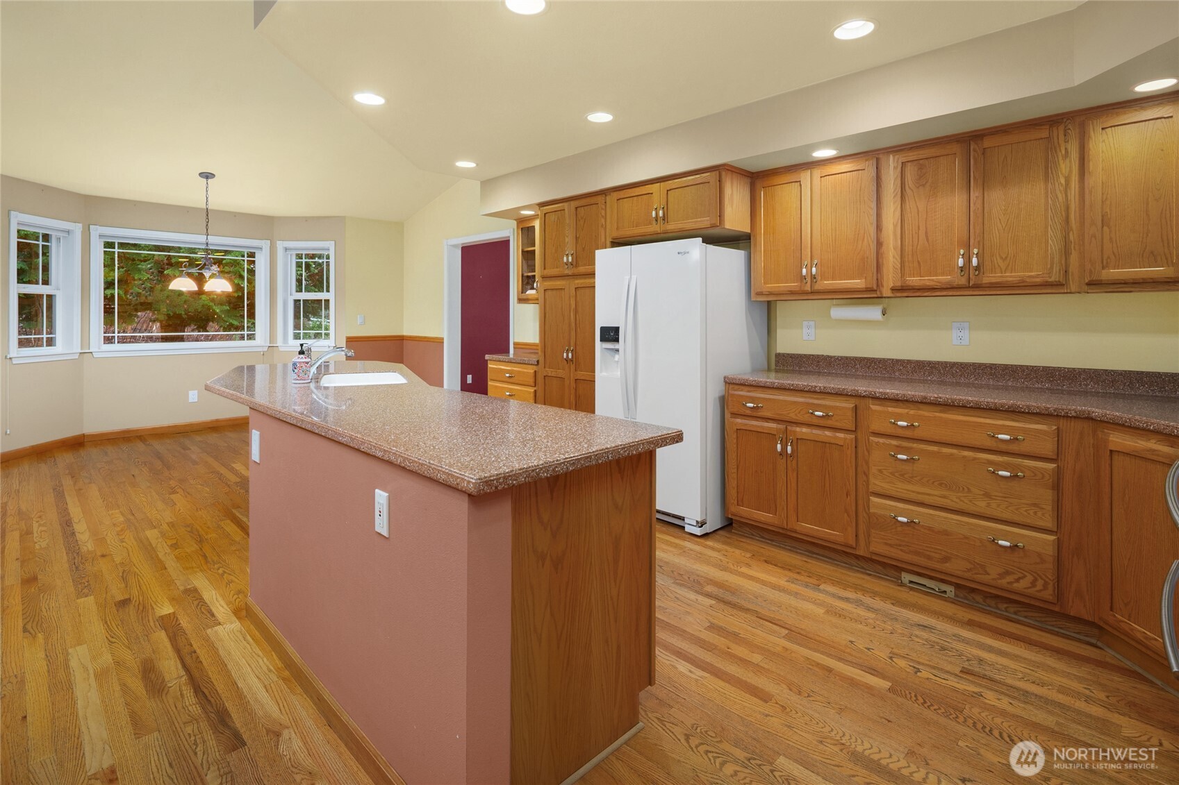 18663 Cascade Ridge Court Mount Vernon, WA 98274 - Photo 19 of 33 a kitchen with refrigerator cabinets and wooden floor