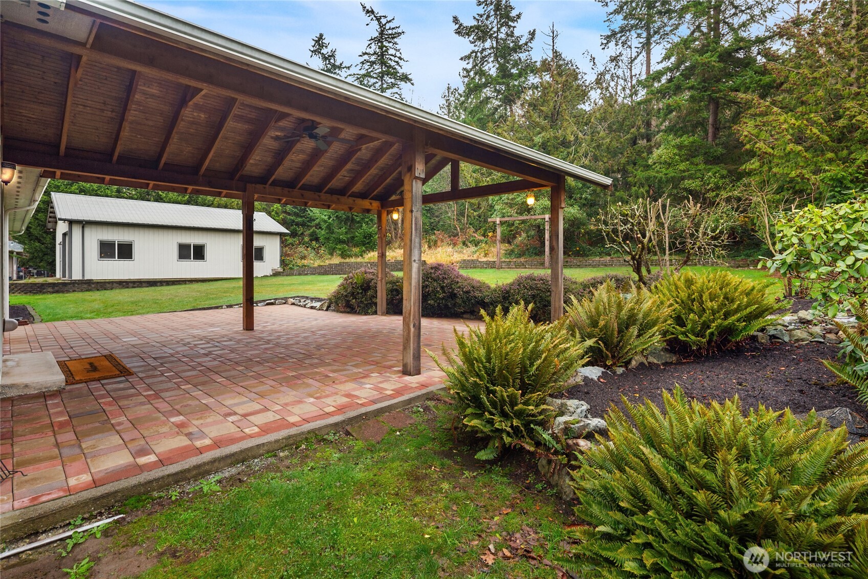 18663 Cascade Ridge Court Mount Vernon, WA 98274 - Photo 7 of 33 a view of a backyard with plants and a patio
