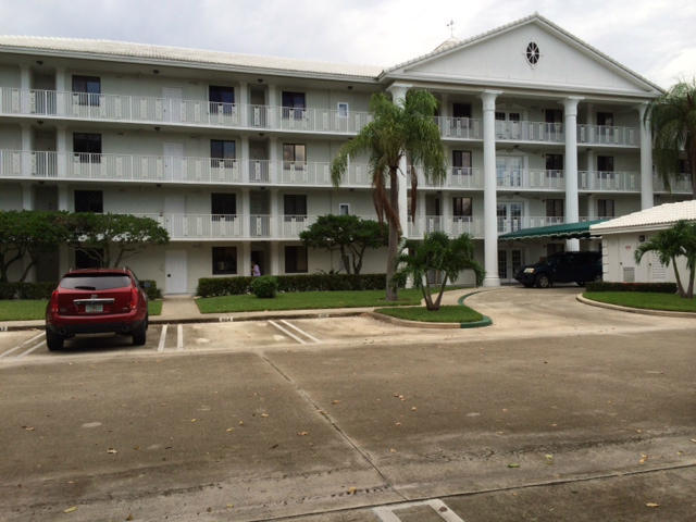 2461 Village Boulevard, Unit 101 West Palm Beach, FL 33409 - Photo 2 of 10 a front view of a house with a yard