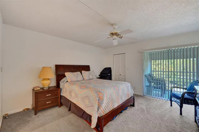 a bedroom with a bed a chandelier and a window
