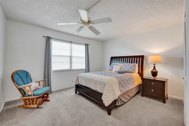 a spacious bedroom with a bed and window