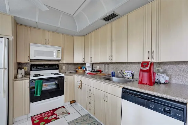 a kitchen with a sink cabinets and stainless steel appliances