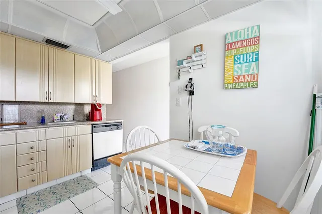 a kitchen with granite countertop a sink a stove and cabinets