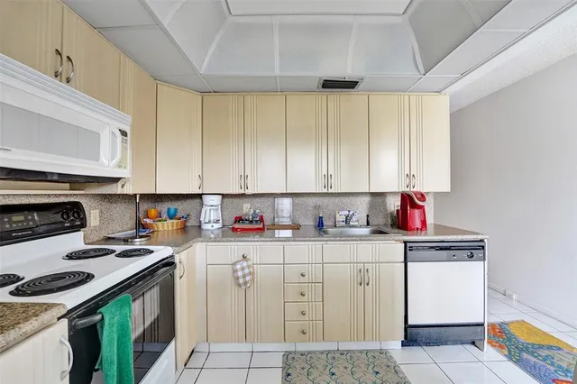 a kitchen with cabinets a stove and a microwave