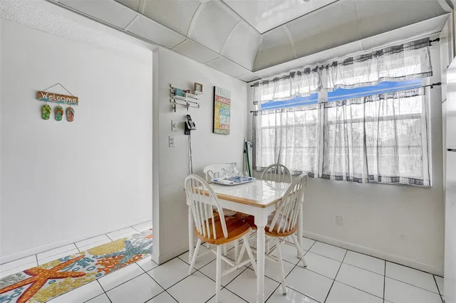 a kitchen with stainless steel appliances a stove a refrigerator and a dining table