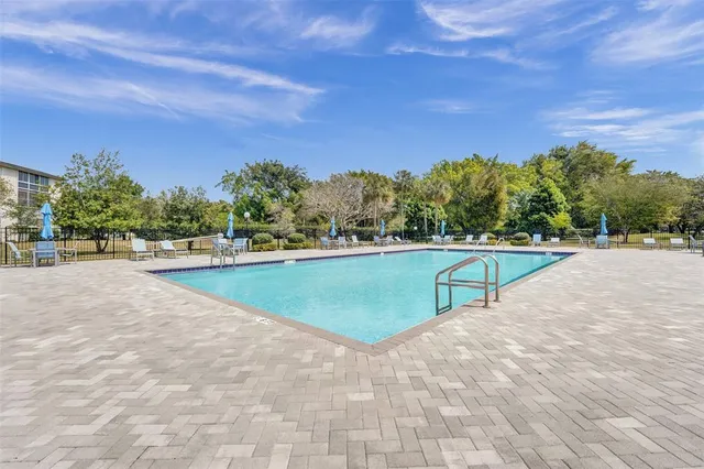 a view of a swimming pool and a yard