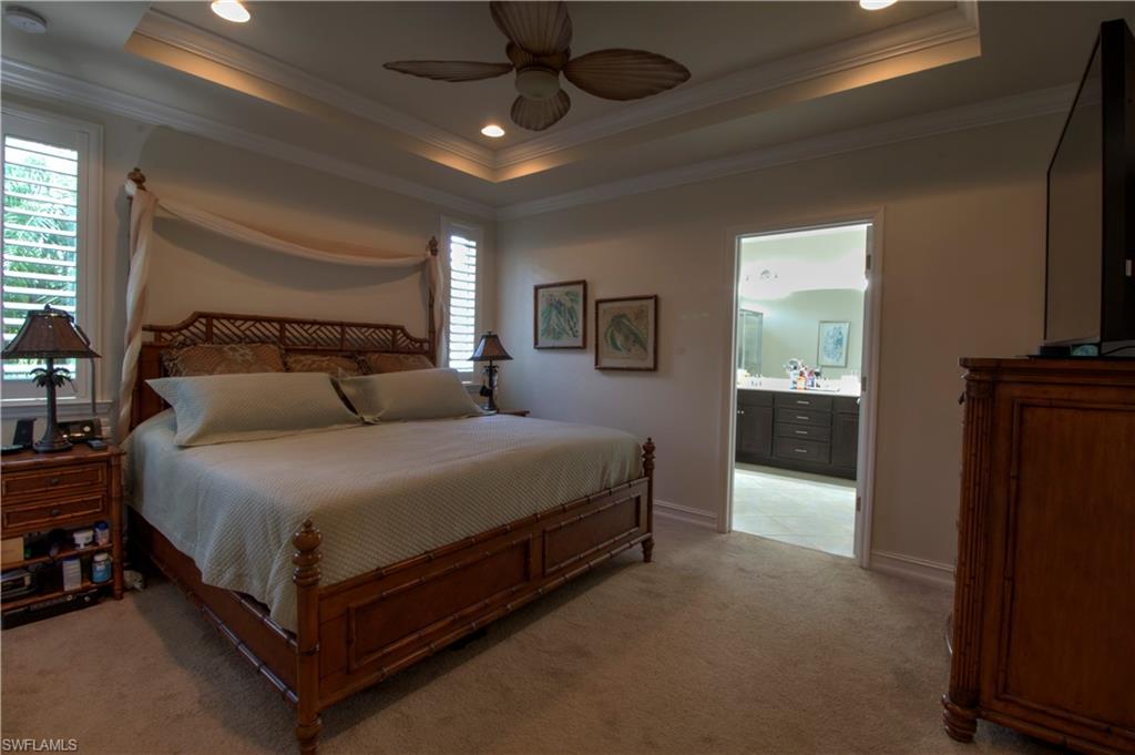 8472 Benelli Court Naples, FL 34114 - Photo 12 of 45 a bed room with a bed and a television