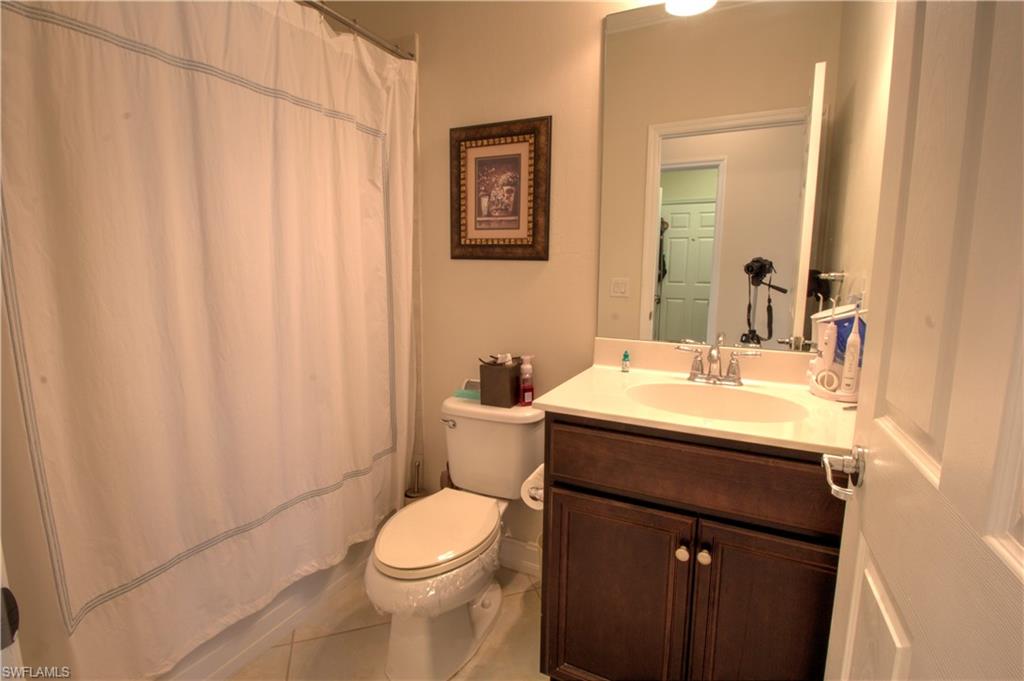 8472 Benelli Court Naples, FL 34114 - Photo 16 of 45 a bathroom with a sink a toilet and mirror