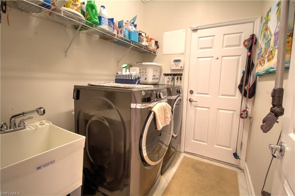 8472 Benelli Court Naples, FL 34114 - Photo 18 of 45 a utility room with dryer and washer