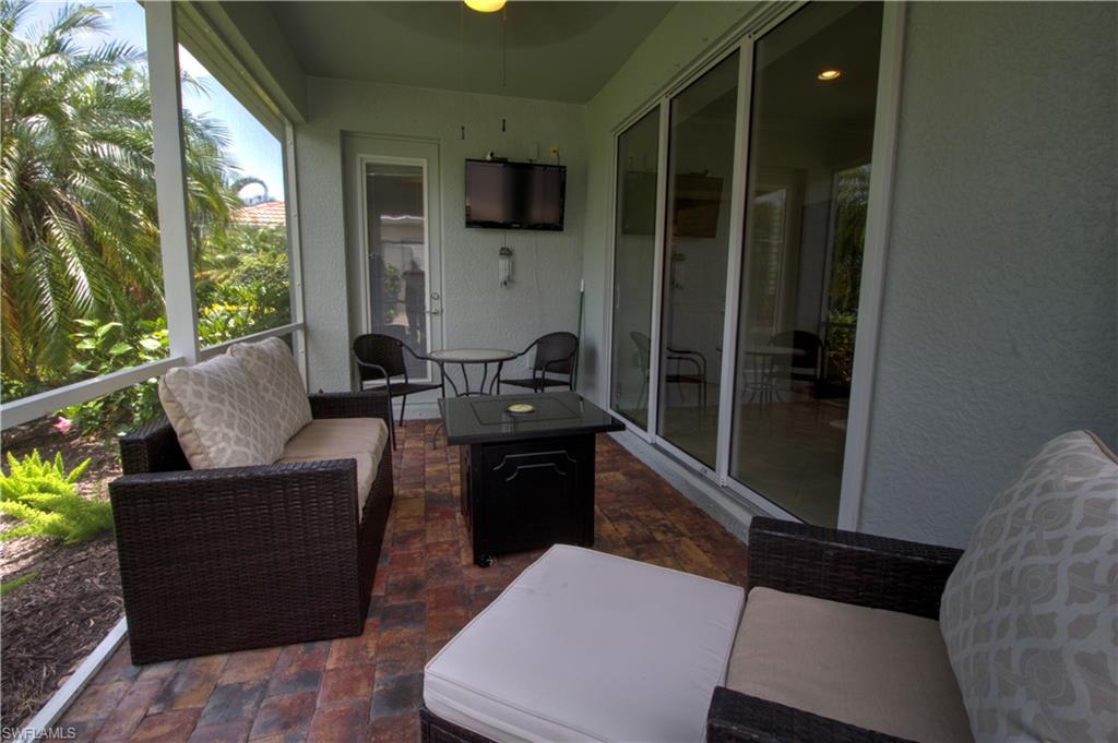 8472 Benelli Court Naples, FL 34114 - Photo 20 of 45 a living room with furniture and a flat screen tv