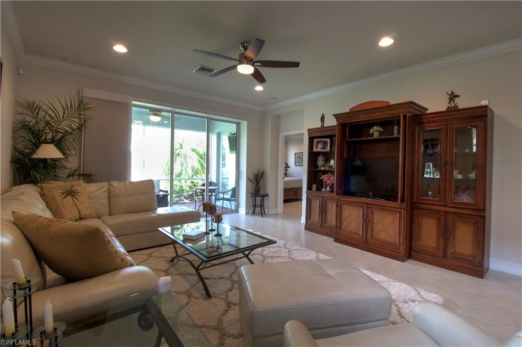 8472 Benelli Court Naples, FL 34114 - Photo 6 of 45 a living room with furniture and a flat screen tv