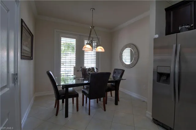 a view of a dining room with furniture and a chandelier