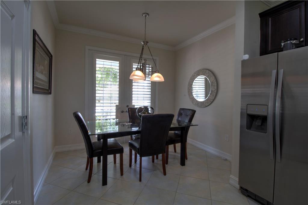8472 Benelli Court Naples, FL 34114 - Photo 10 of 45 a view of a dining room with furniture and a chandelier