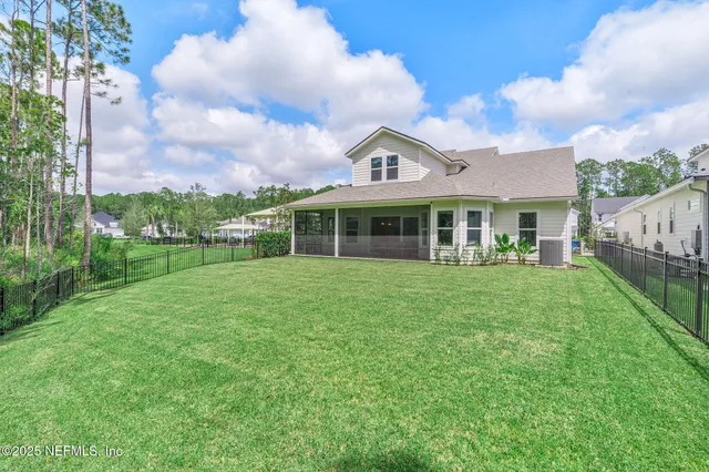 a aerial view of a house with a yard and pool