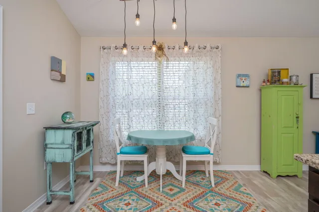 a view of a dining room with furniture and a chandelier