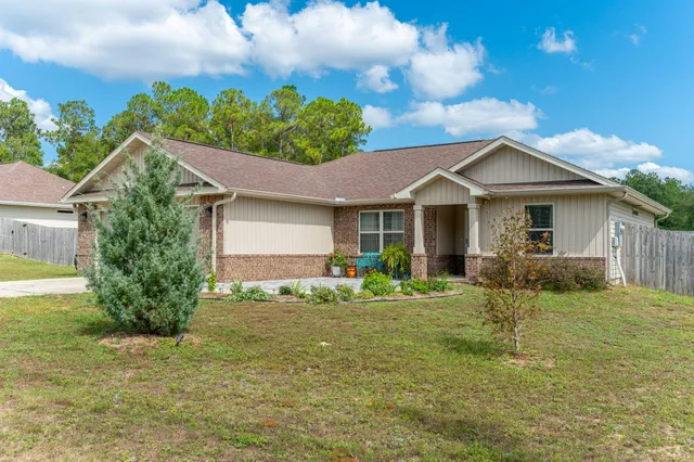 a front view of a house with a yard and porch