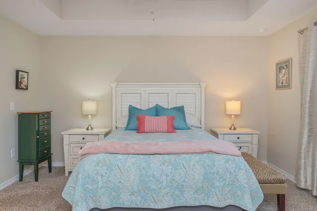 a bedroom with a large bed and a night stand