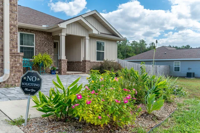 a front view of house with yard and outdoor seating