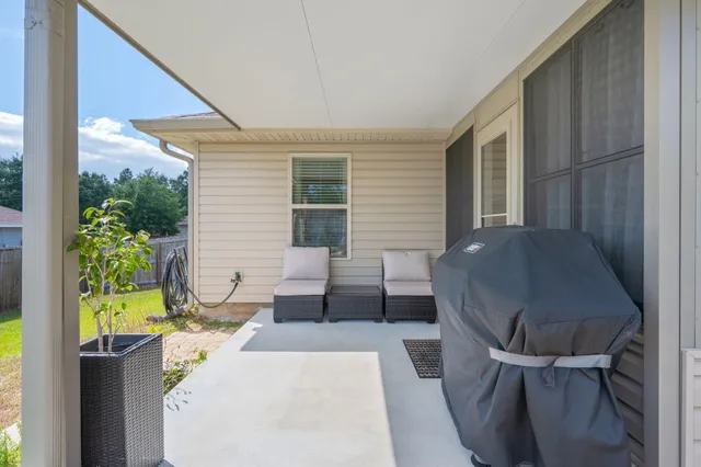 a view of a patio with table and chairs and potted plants