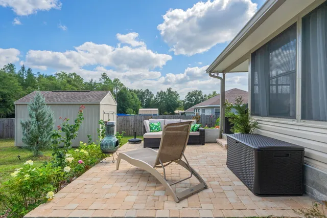 a view of a patio with couches table and chairs and potted plants