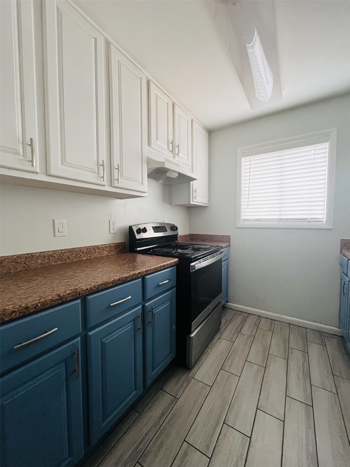 5123 Del Monte Drive, Unit 2 Houston, TX 77056 - Photo 5 of 12 a kitchen with stainless steel appliances granite countertop a stove a sink and dishwasher with white cabinets